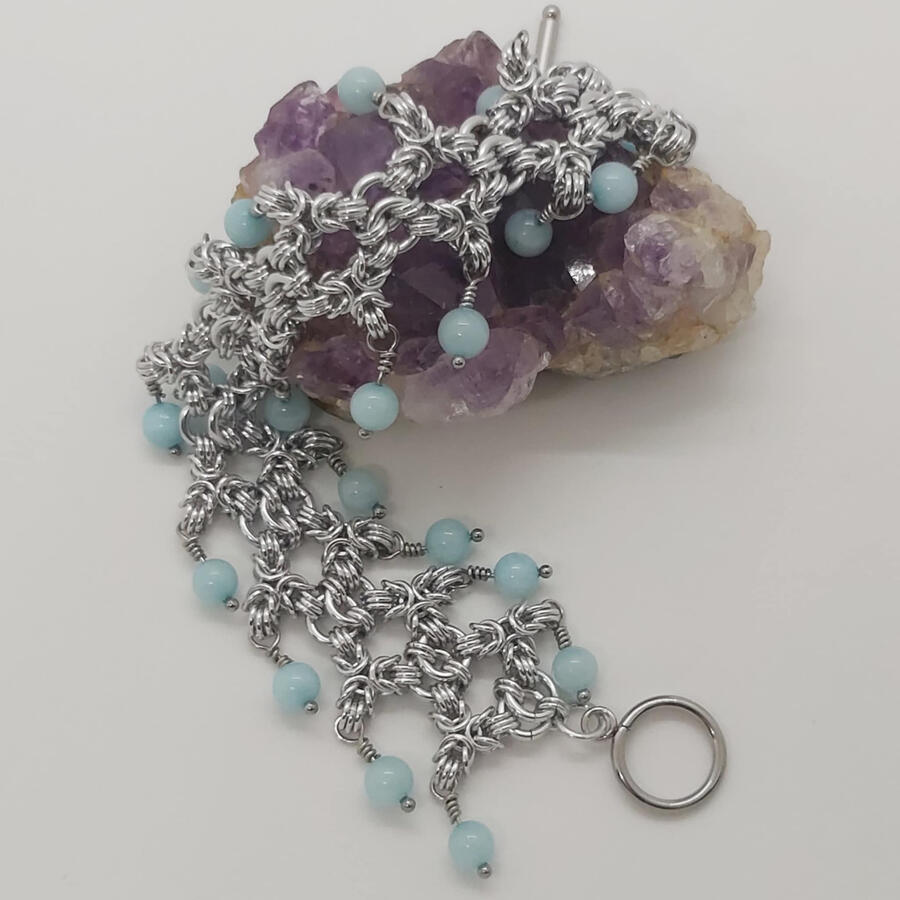 Namaste Tripoli, made with anodized aluminum rings and chalcedony beads. Toggle and head pins are stainless steel.