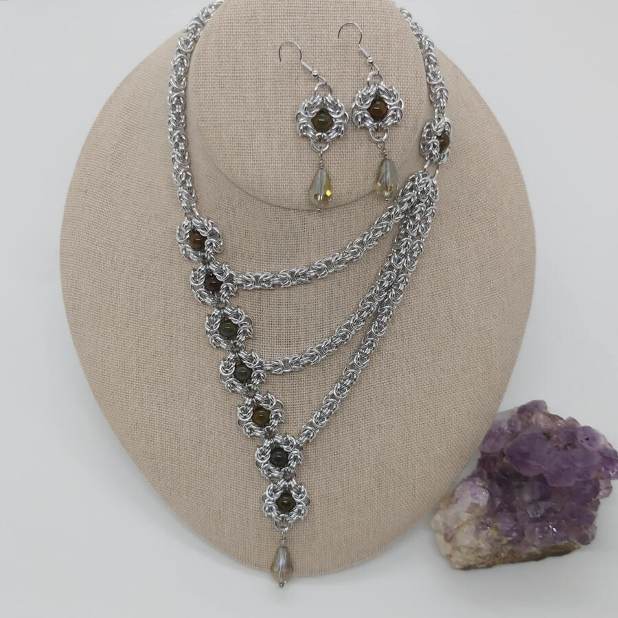 Asymmetrical Dragon, made with anodized aluminum, dragon agate/glass beads, and stainless steel.