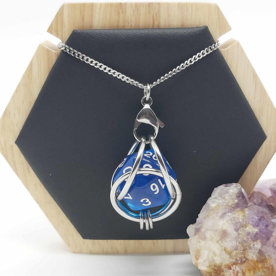 Captured D20 pendant. Made with stainless steel and a 20 sided die.